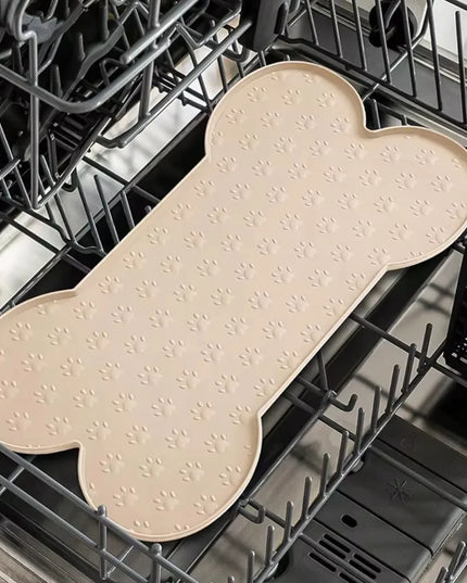 DKM silikoninis padėklas dubenėliams šunims ir katėms 50x26 cm, kaulo formos, smėlio spalvos